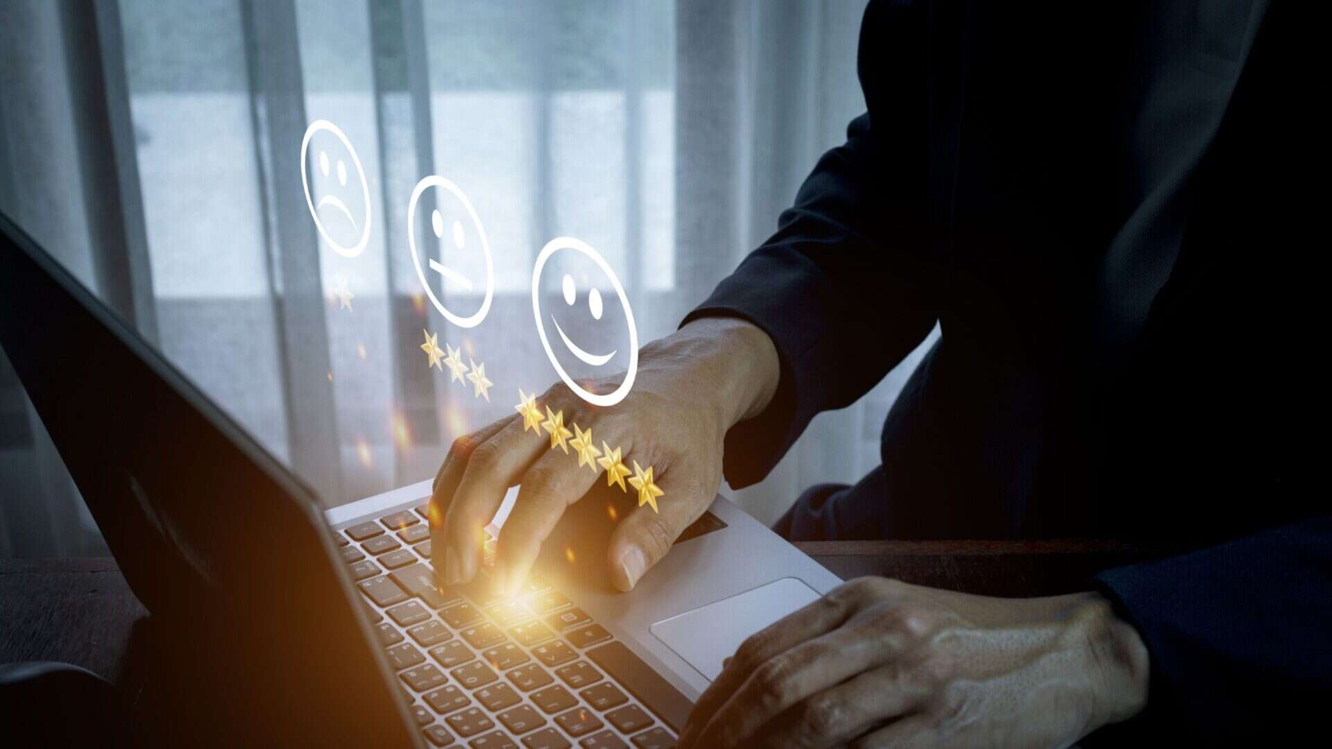 When Chatbots Go Wrong: The New Risk Landscape in AI Customer Service 1 Image of hands at a laptop screen with customer experience sentiment emojis floating above.
